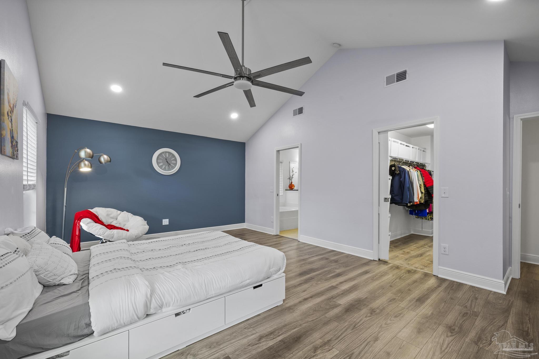 5981 Dunridge Drive Pace, FL 32571 - Photo 19 of 39 a bedroom with a bed and a chandelier