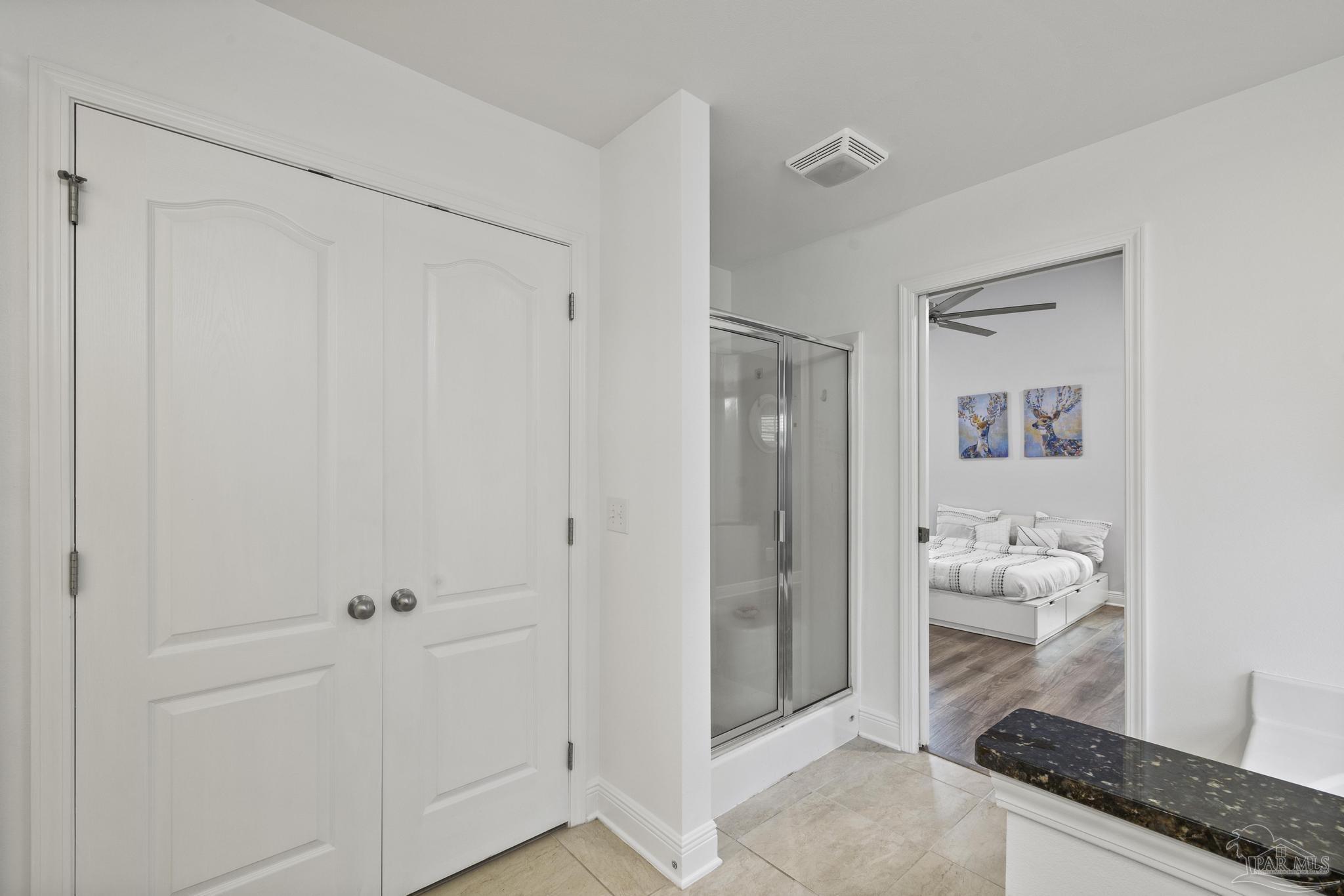 5981 Dunridge Drive Pace, FL 32571 - Photo 23 of 39 a bathroom with a granite countertop sink a mirror and shower