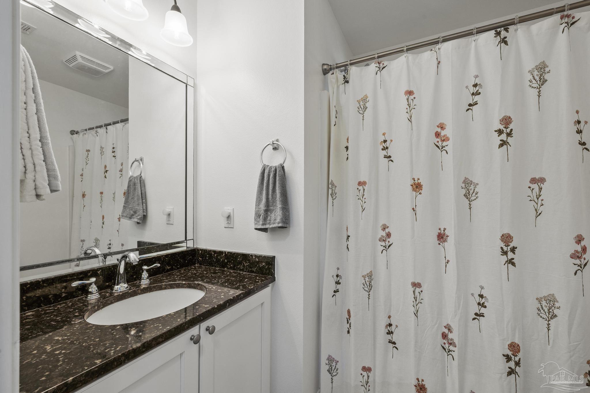 5981 Dunridge Drive Pace, FL 32571 - Photo 26 of 39 a bathroom with a granite countertop sink and a mirror