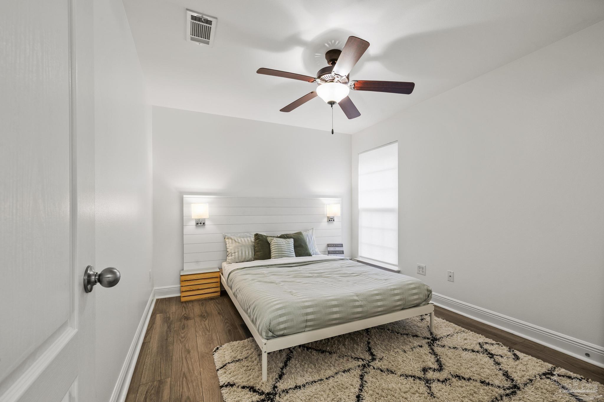 5981 Dunridge Drive Pace, FL 32571 - Photo 27 of 39 a bedroom with a bed and a chandelier