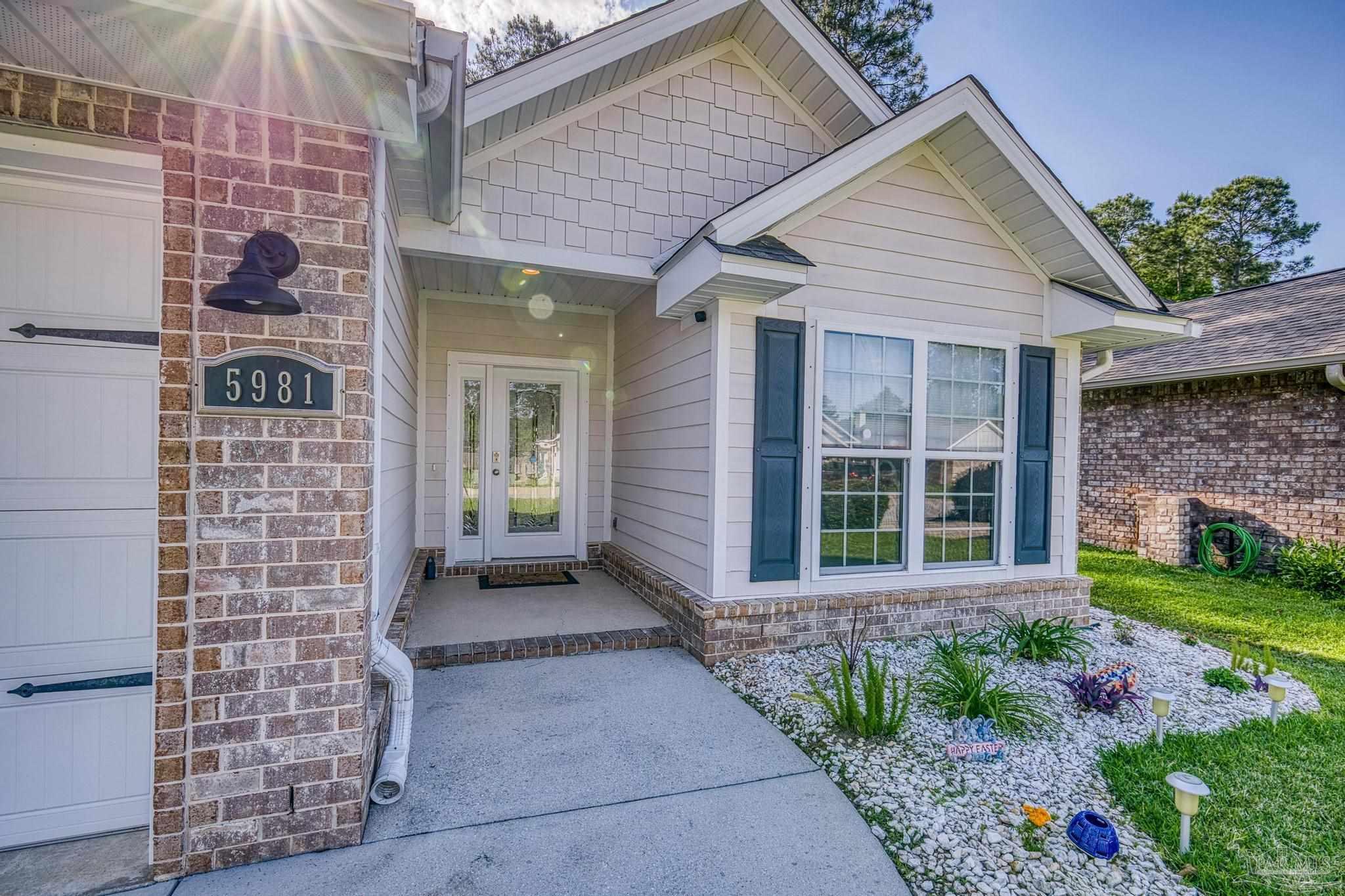 5981 Dunridge Drive Pace, FL 32571 - Photo 3 of 39 a view of a brick house with front door