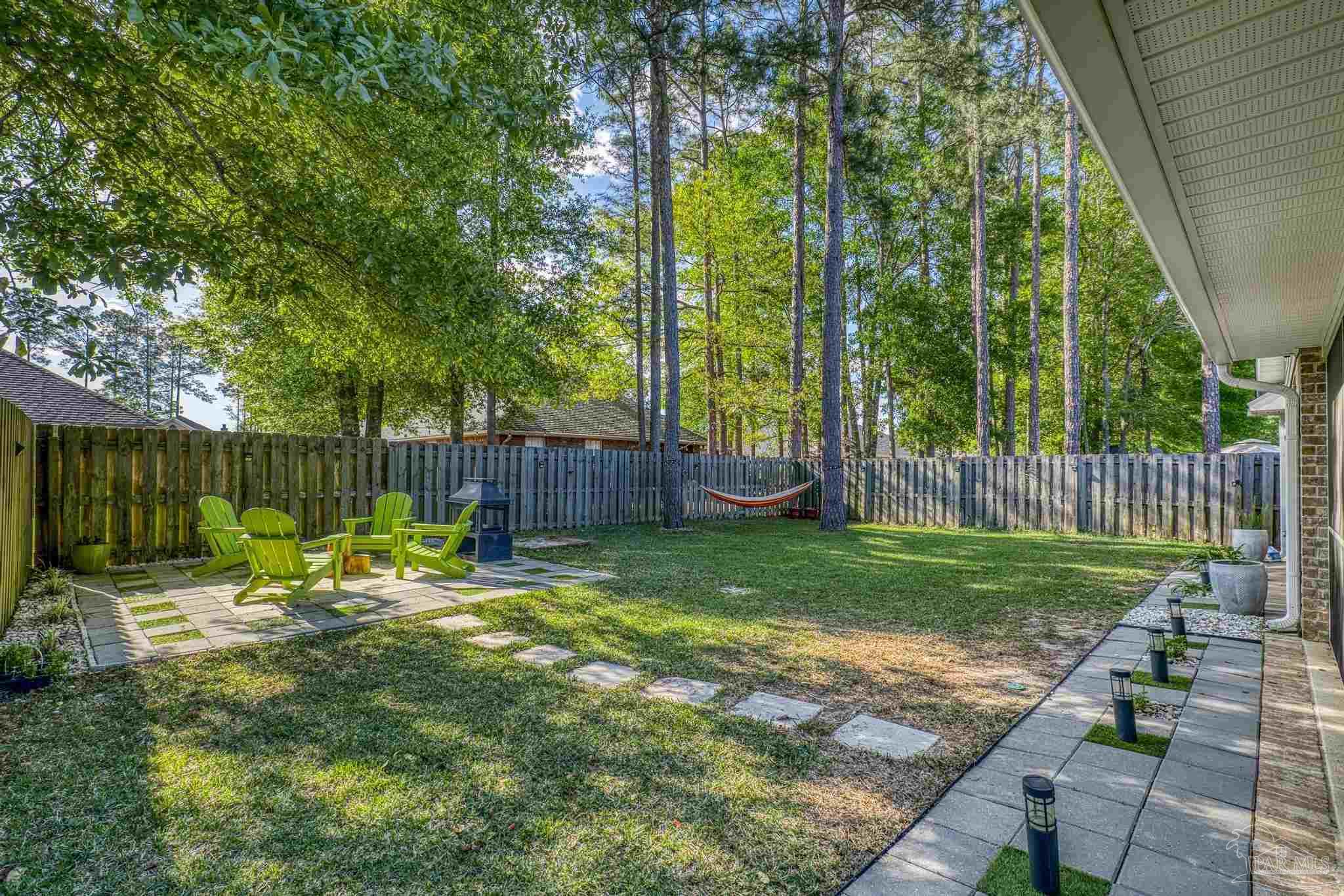 5981 Dunridge Drive Pace, FL 32571 - Photo 31 of 39 a view of back yard with green space and seating