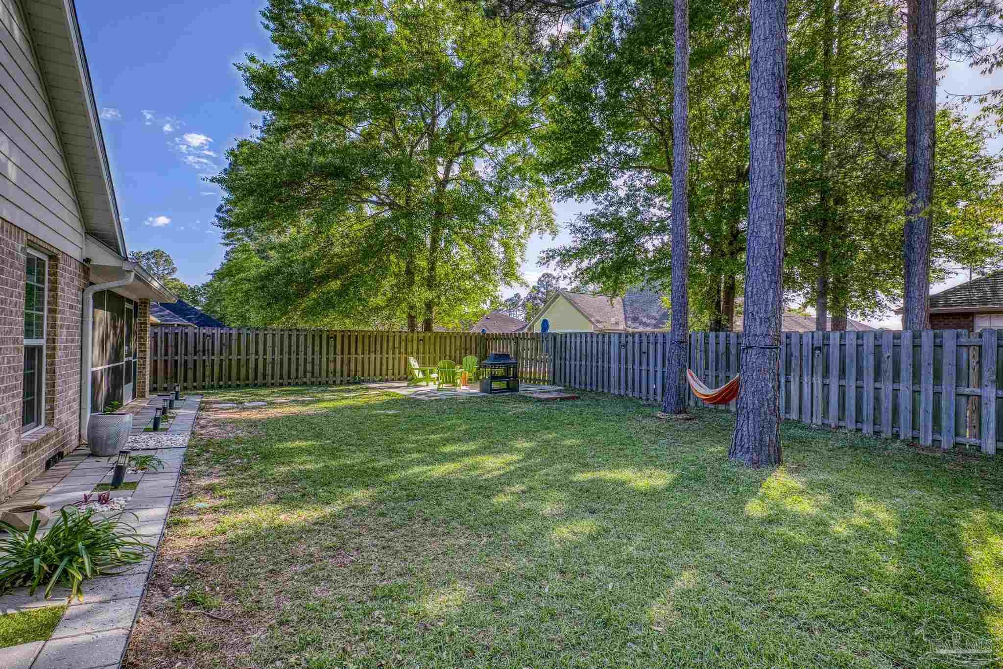 5981 Dunridge Drive Pace, FL 32571 - Photo 34 of 39 a view of a yard with a and a large tree