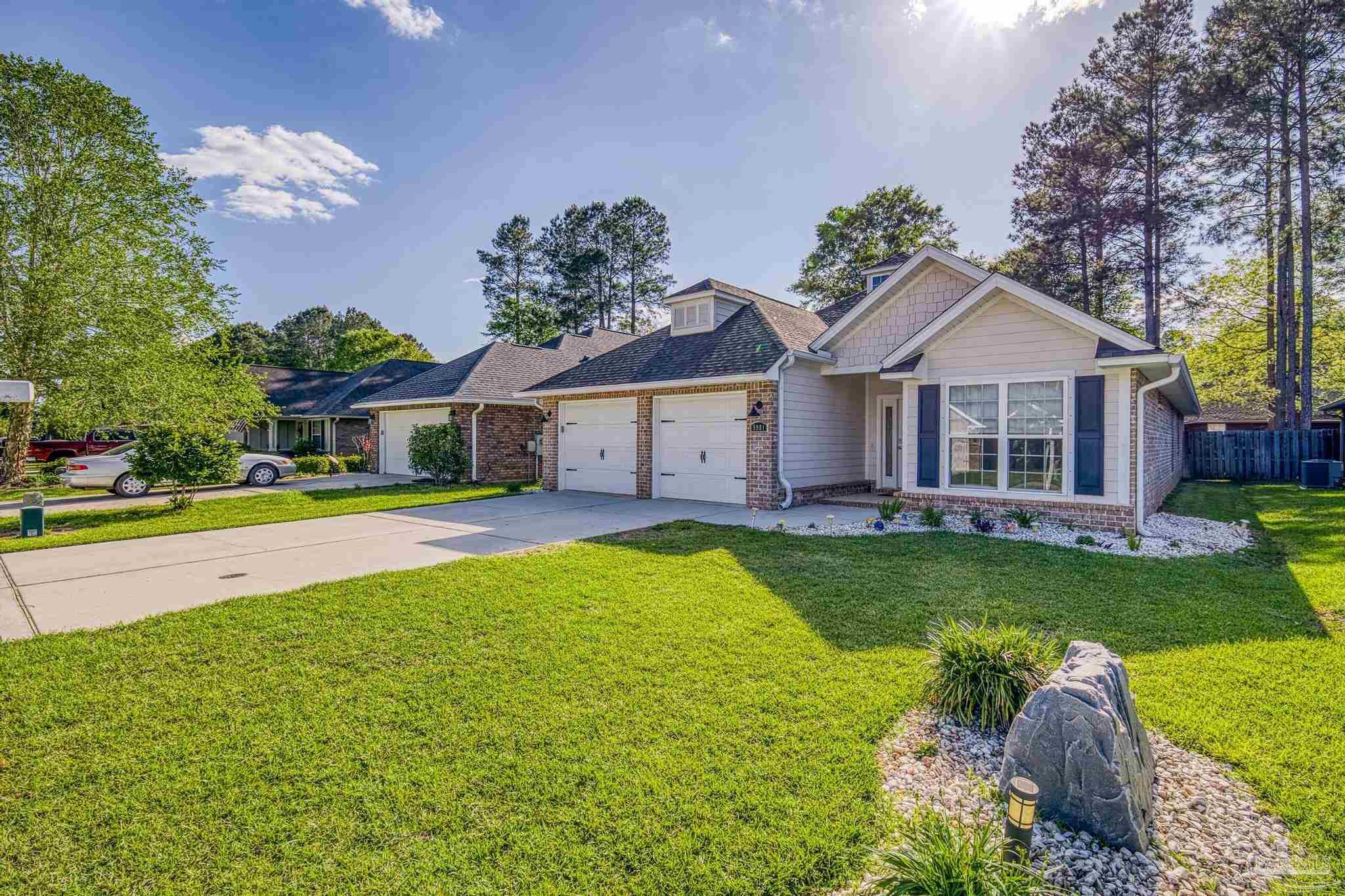 5981 Dunridge Drive Pace, FL 32571 - Photo 36 of 39 a front view of a house with yard and green space