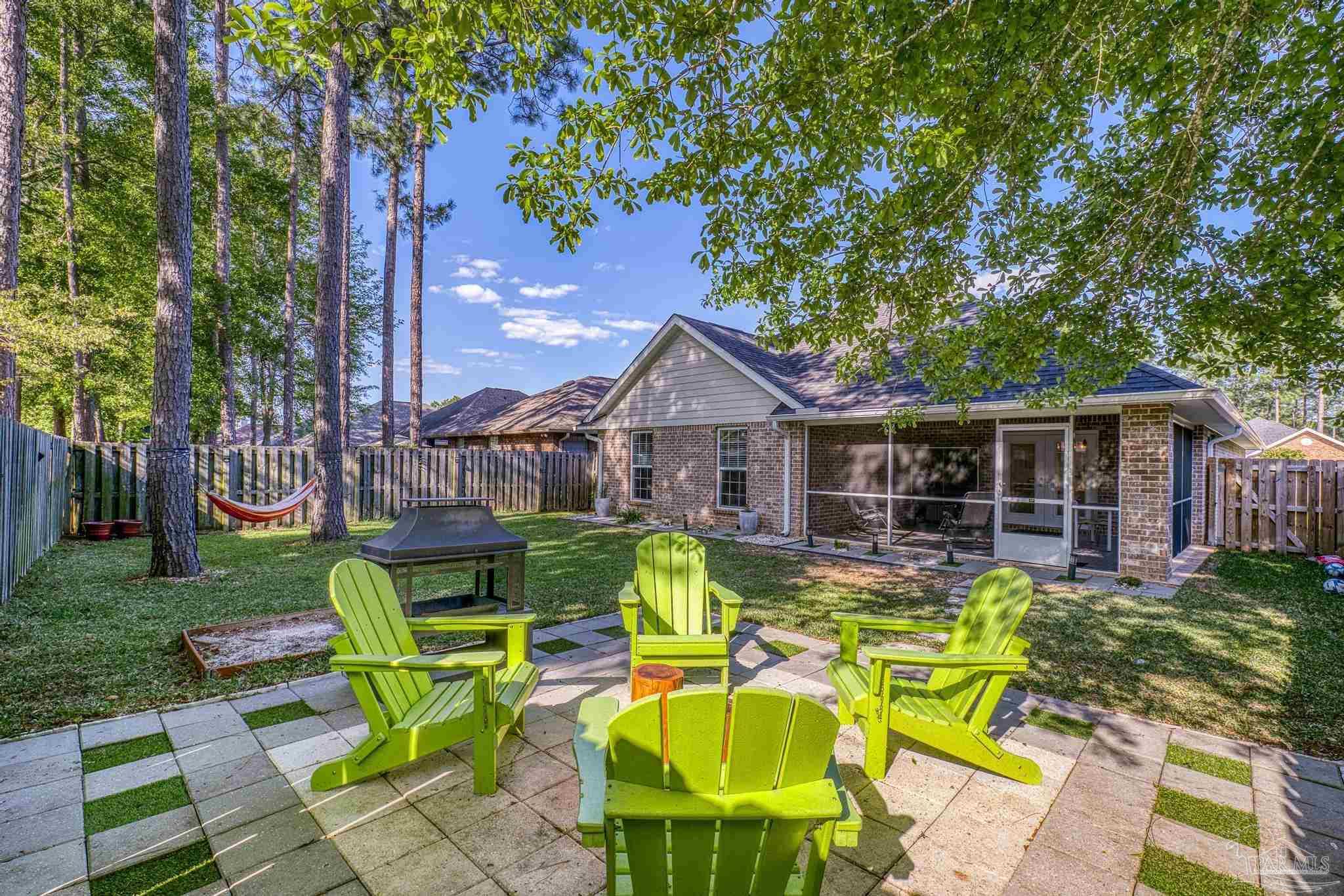 5981 Dunridge Drive Pace, FL 32571 - Photo 4 of 39 a view of a house with backyard sitting area and garden