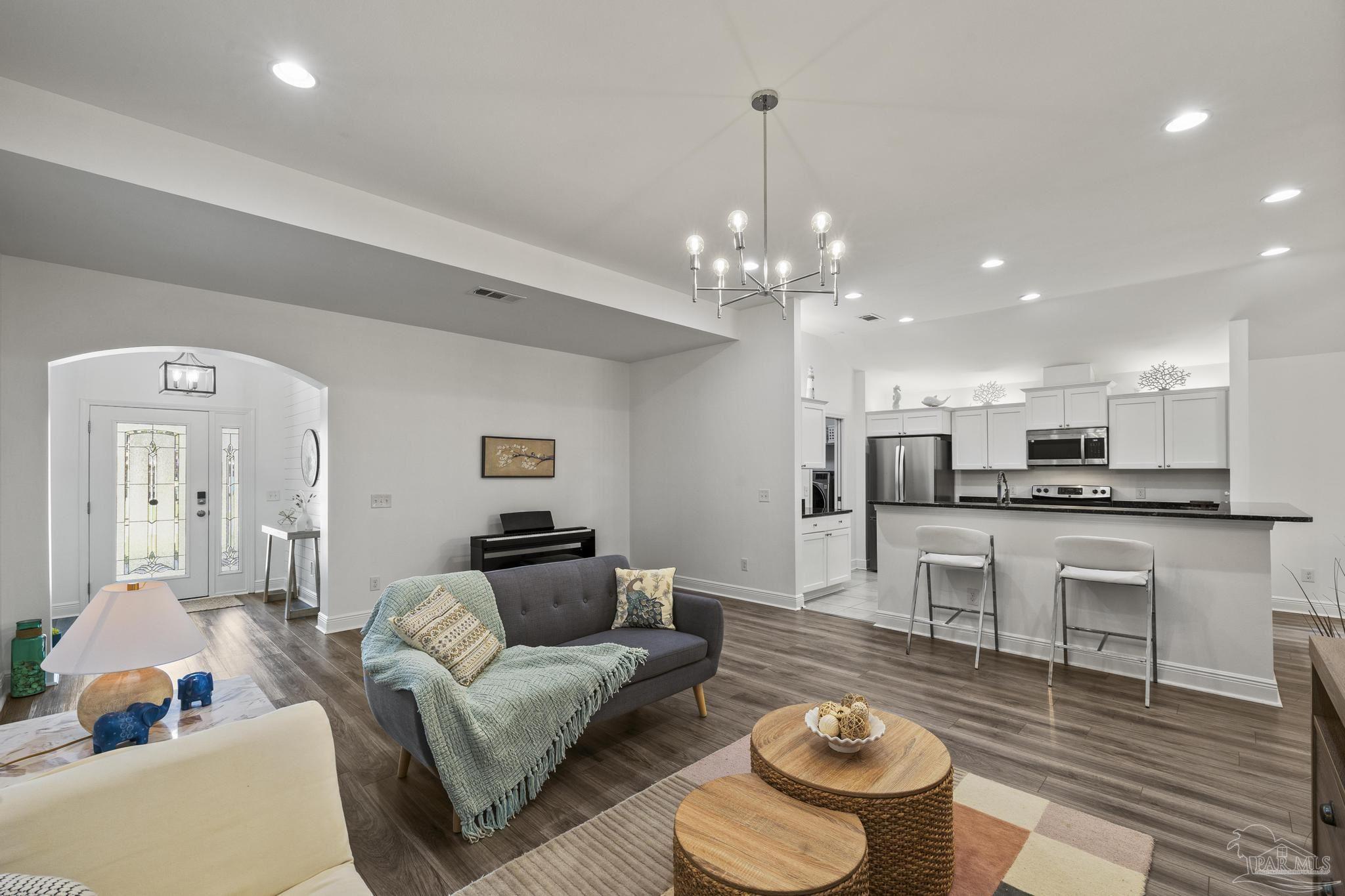 5981 Dunridge Drive Pace, FL 32571 - Photo 10 of 39 a living room with kitchen and a couch