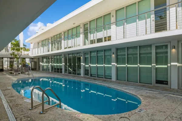 a view of a swimming pool with sitting space
