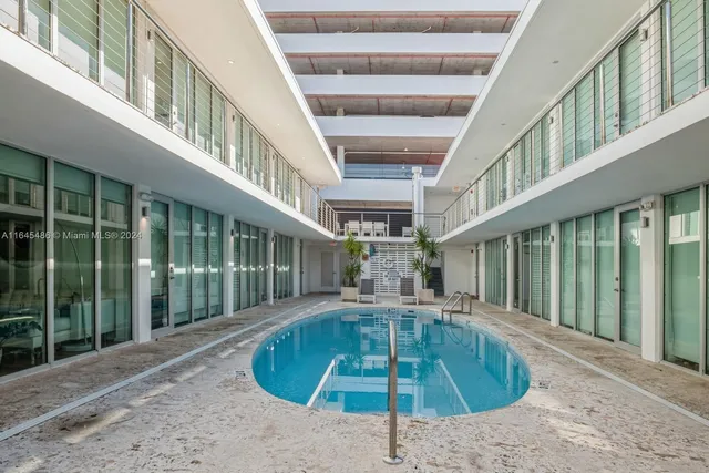 a swimming pool with an outdoor view and seating