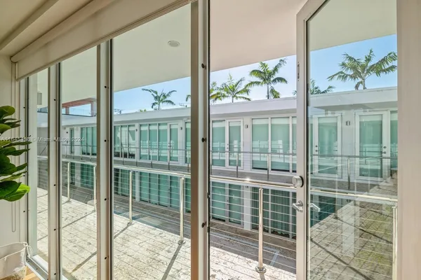a view of a porch with a floor to ceiling window and wooden floor