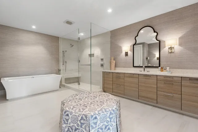 a spacious bathroom with a double vanity sink mirror and bathtub