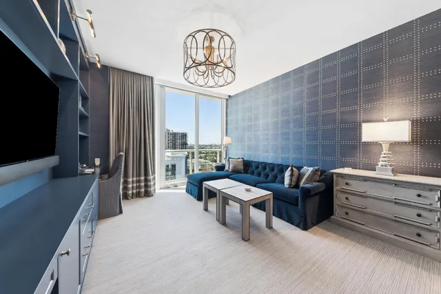 a work room with furniture and a flat screen tv