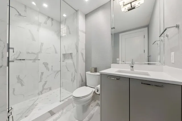 a bathroom with a sink toilet and shower