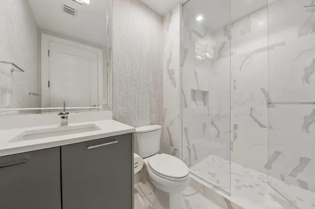 a bathroom with a sink toilet and shower