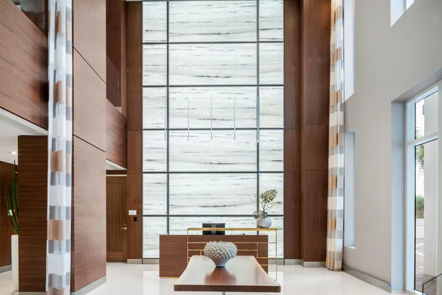 a living room filled with furniture and a large window