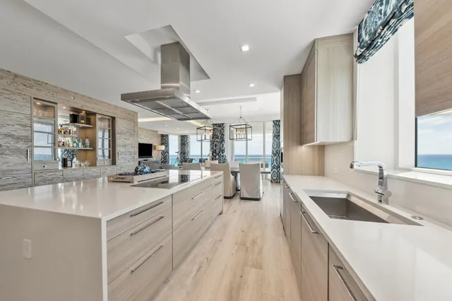 a large white kitchen with a large window