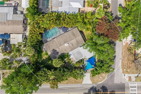 an aerial view of a house with a yard and garden