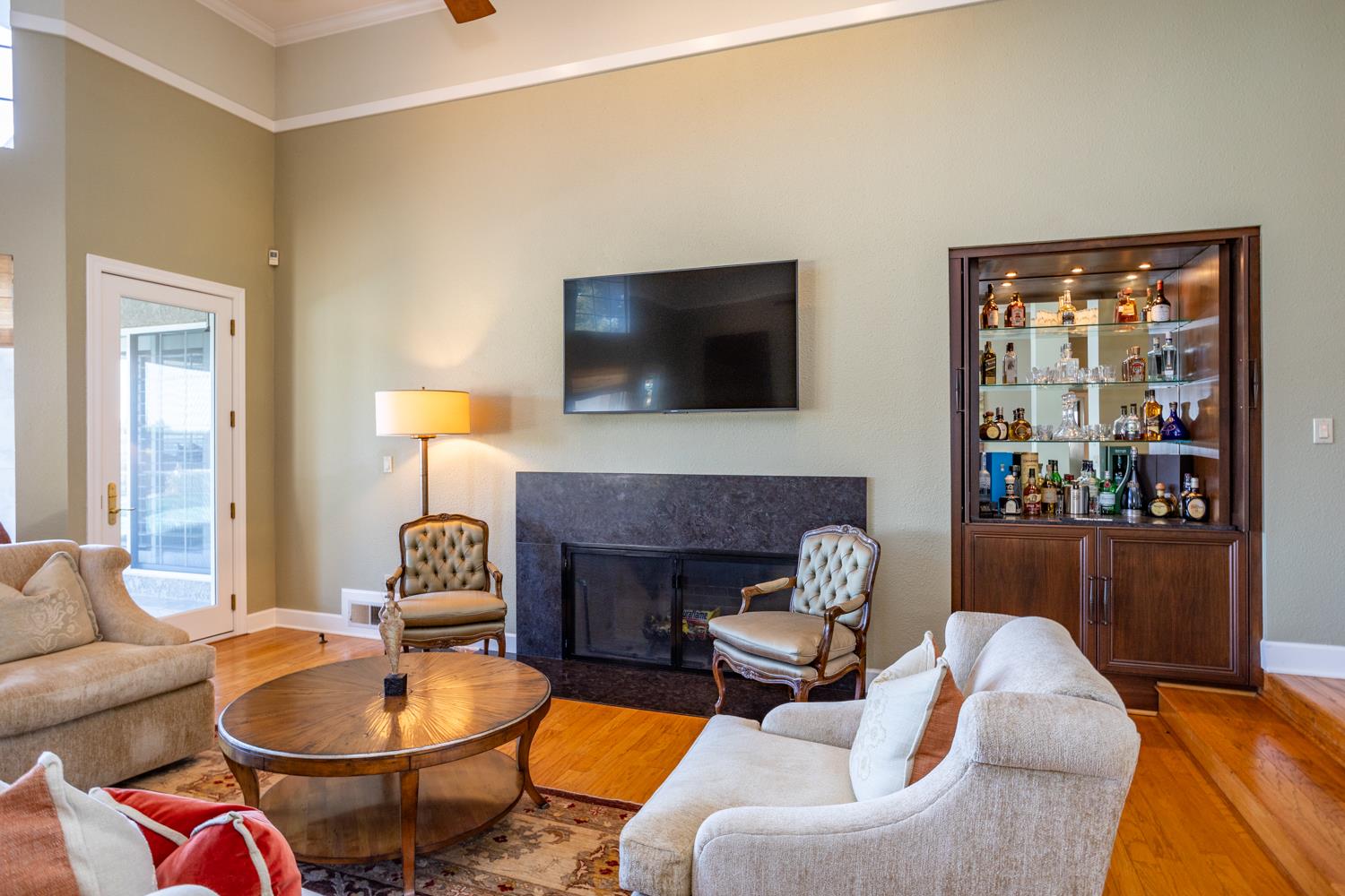 808 Country Club Drive Modesto, CA 95356 - Photo 19 of 60 a living room with furniture a fireplace and a flat screen tv