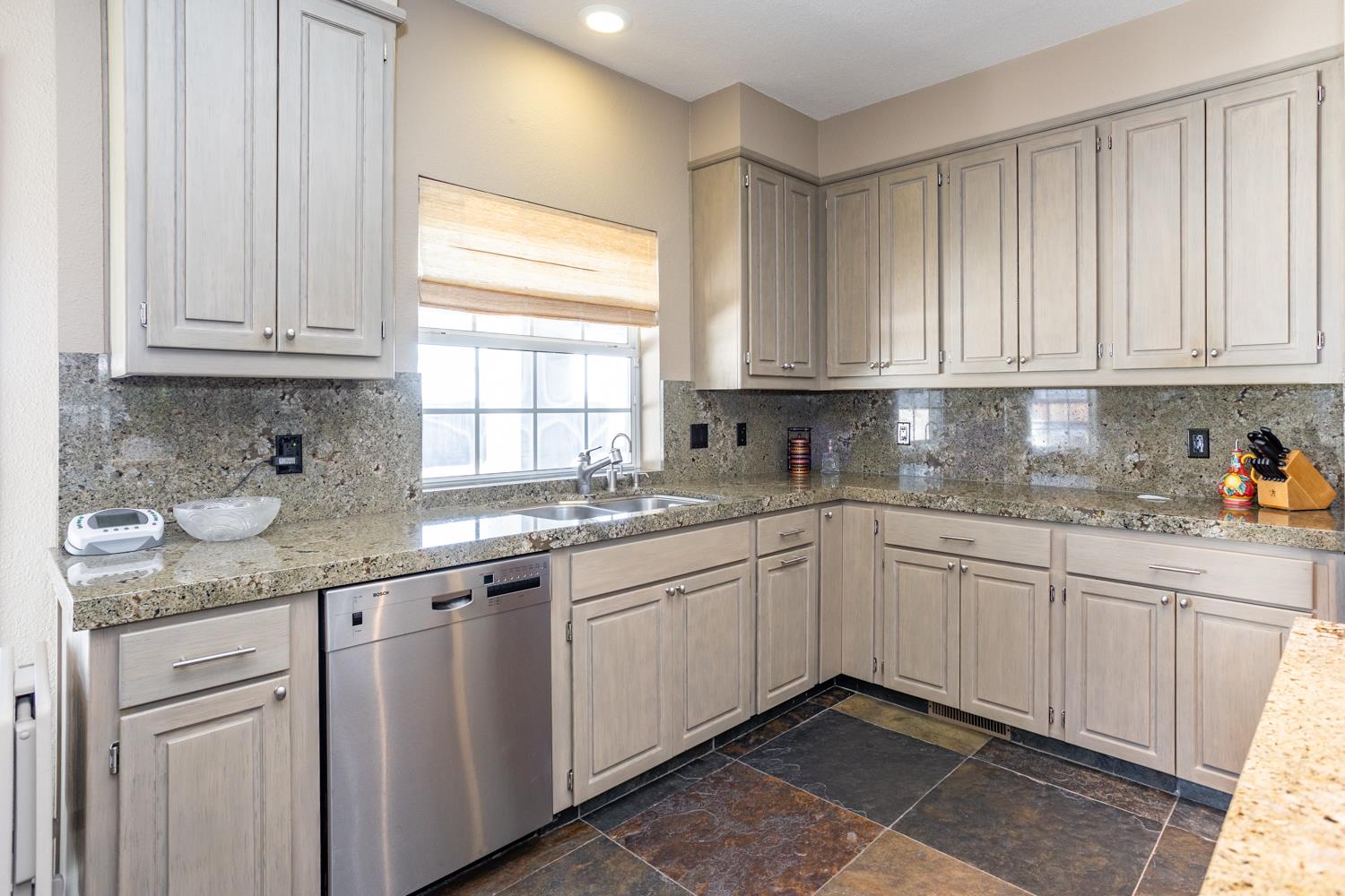 808 Country Club Drive Modesto, CA 95356 - Photo 25 of 60 a kitchen with granite countertop cabinets sink and window