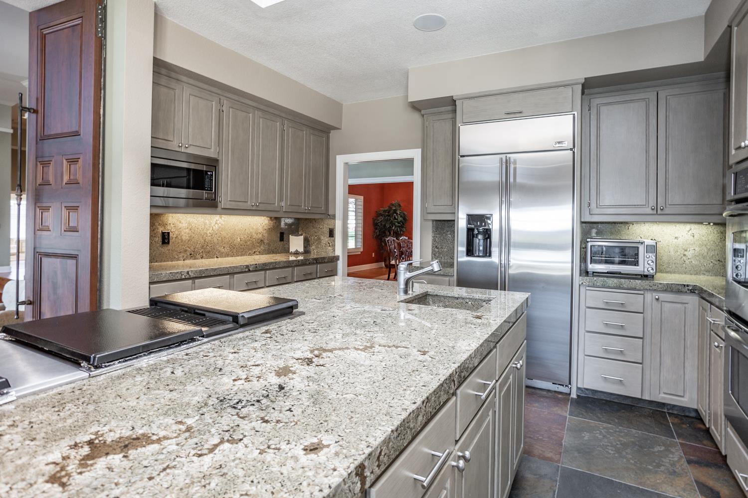 808 Country Club Drive Modesto, CA 95356 - Photo 26 of 60 a kitchen with stainless steel appliances granite countertop a sink stove and refrigerator