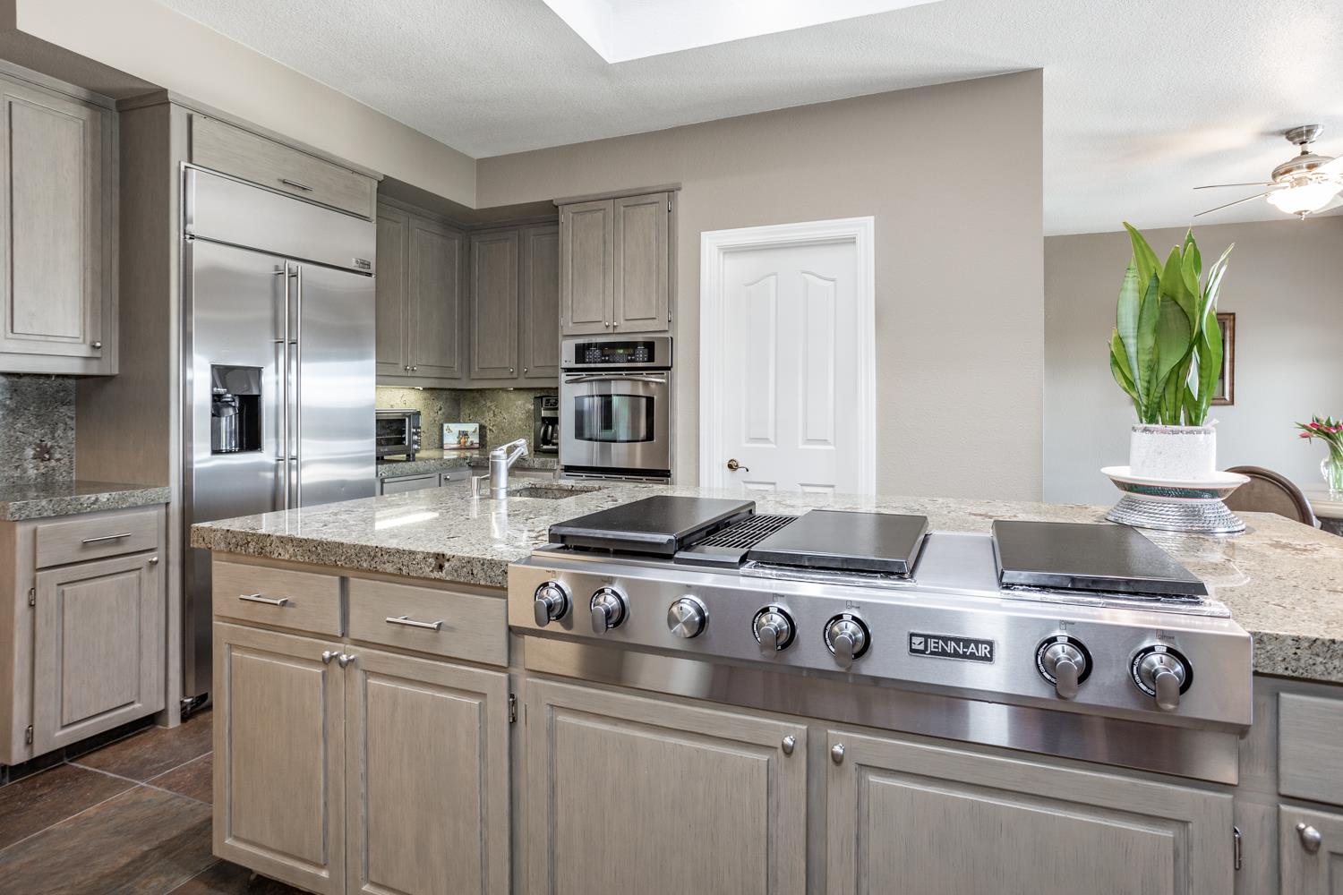 808 Country Club Drive Modesto, CA 95356 - Photo 27 of 60 a kitchen with stainless steel appliances granite countertop a stove a sink and white cabinets