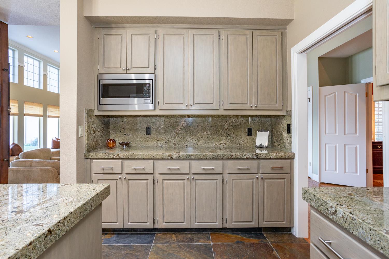 808 Country Club Drive Modesto, CA 95356 - Photo 28 of 60 a kitchen with stainless steel appliances granite countertop a sink stove and cabinets