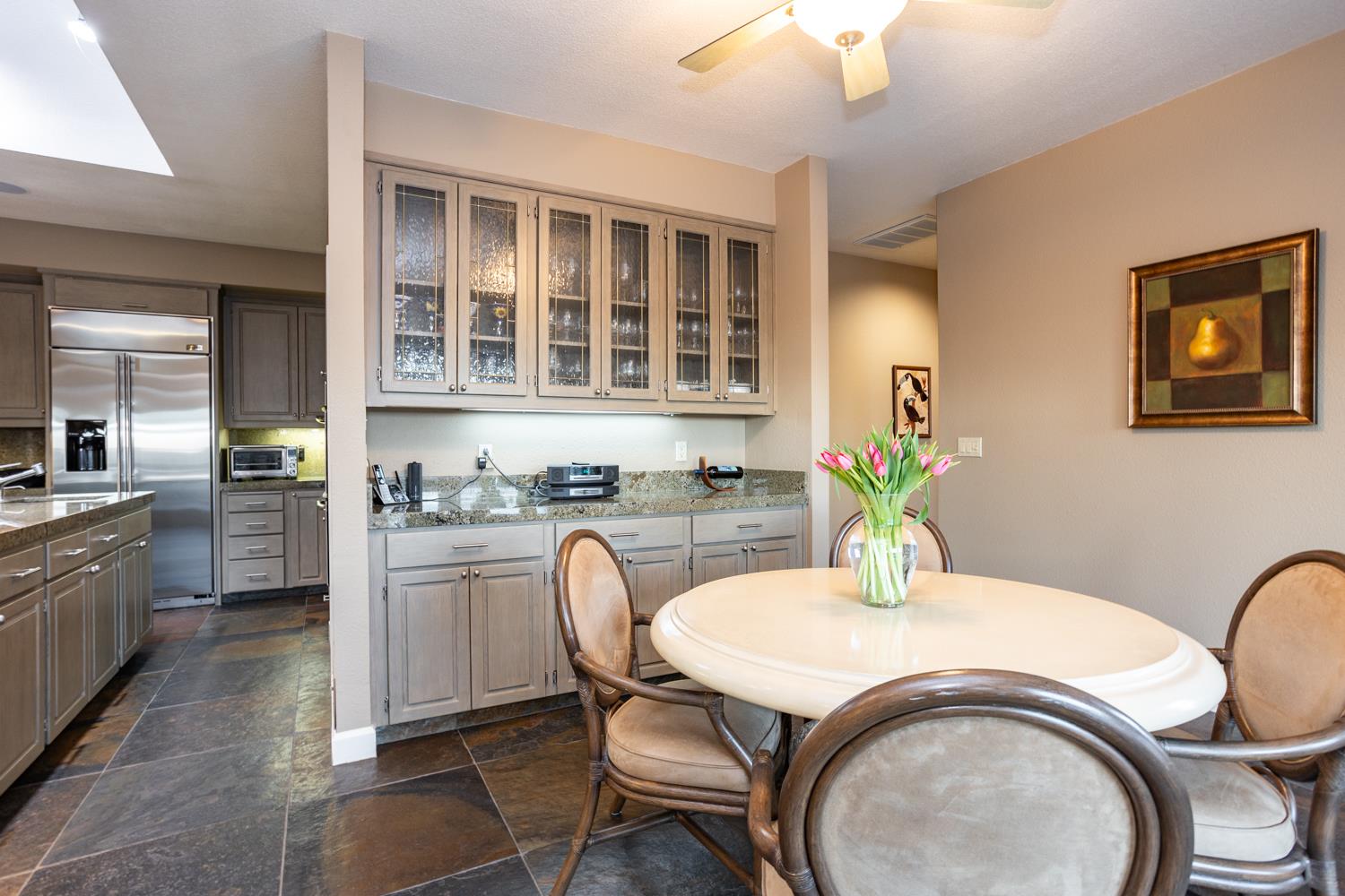 808 Country Club Drive Modesto, CA 95356 - Photo 31 of 60 a dining room with a wooden table and chairs