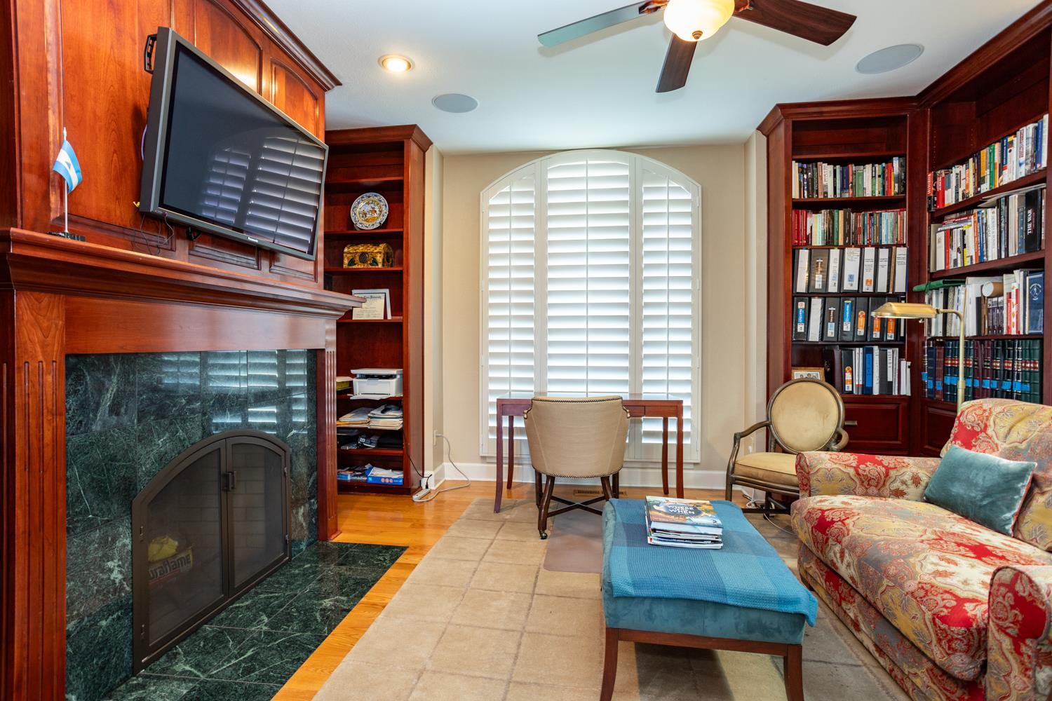 808 Country Club Drive Modesto, CA 95356 - Photo 33 of 60 a living room with furniture a fireplace and a bookshelf
