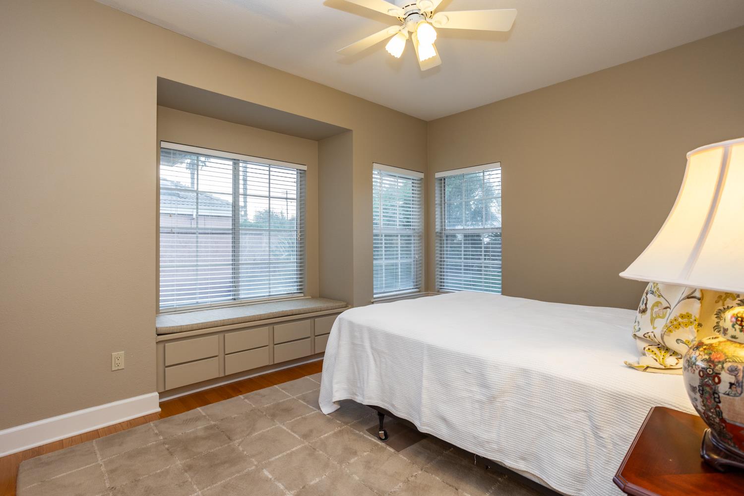 808 Country Club Drive Modesto, CA 95356 - Photo 42 of 60 a bedroom with a bed and a chandelier