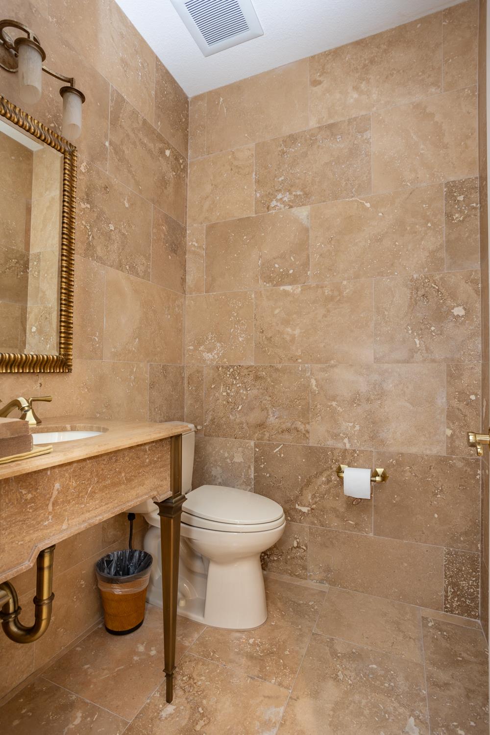 808 Country Club Drive Modesto, CA 95356 - Photo 51 of 60 a bathroom with a toilet sink and mirror