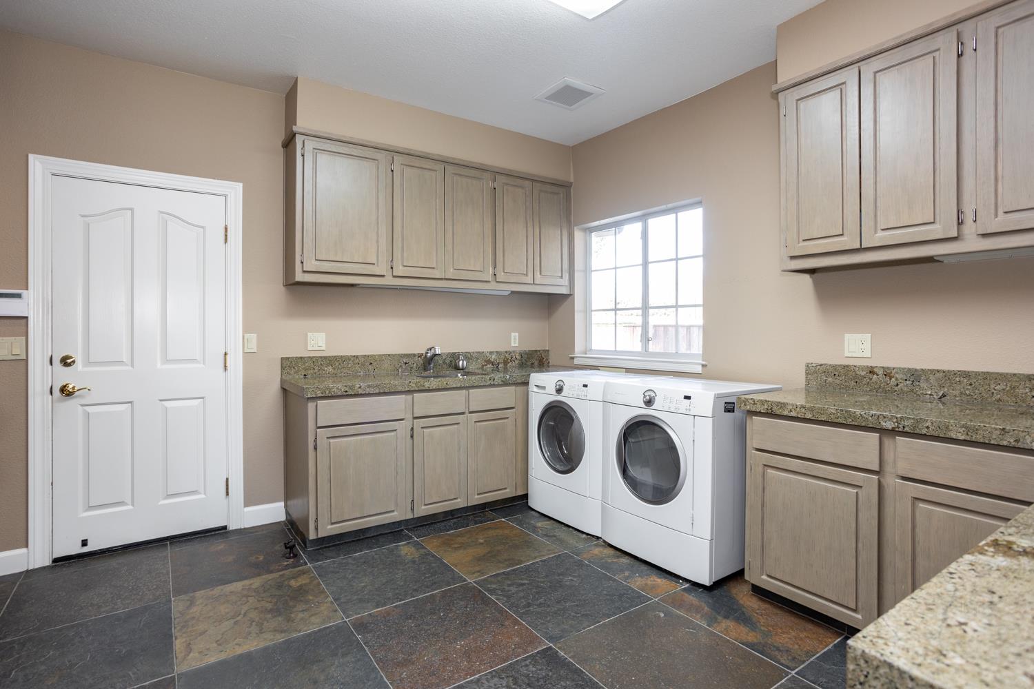 808 Country Club Drive Modesto, CA 95356 - Photo 52 of 60 a utility room with sink dryer and washer