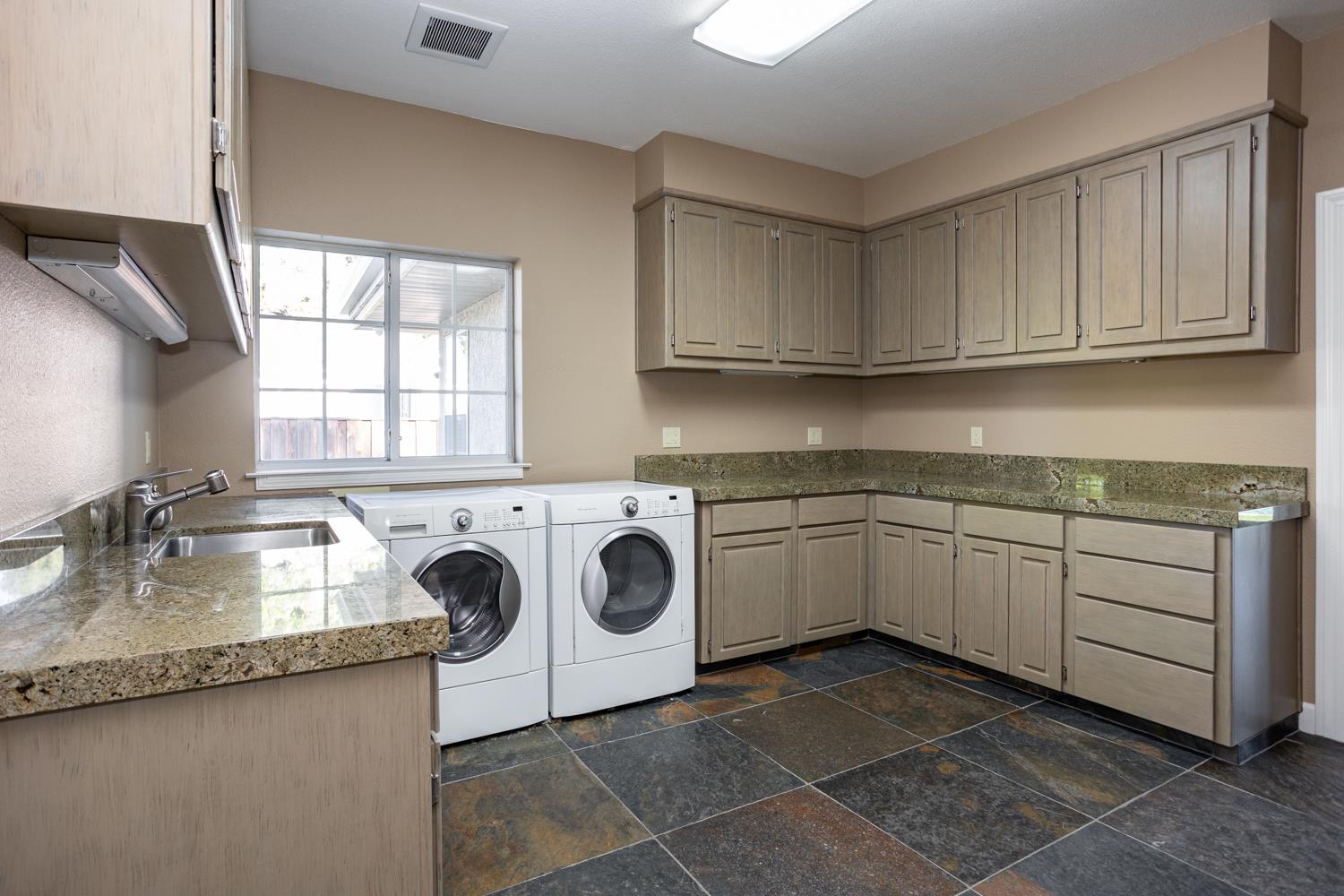 808 Country Club Drive Modesto, CA 95356 - Photo 53 of 60 a kitchen with granite countertop a sink a stove and cabinets