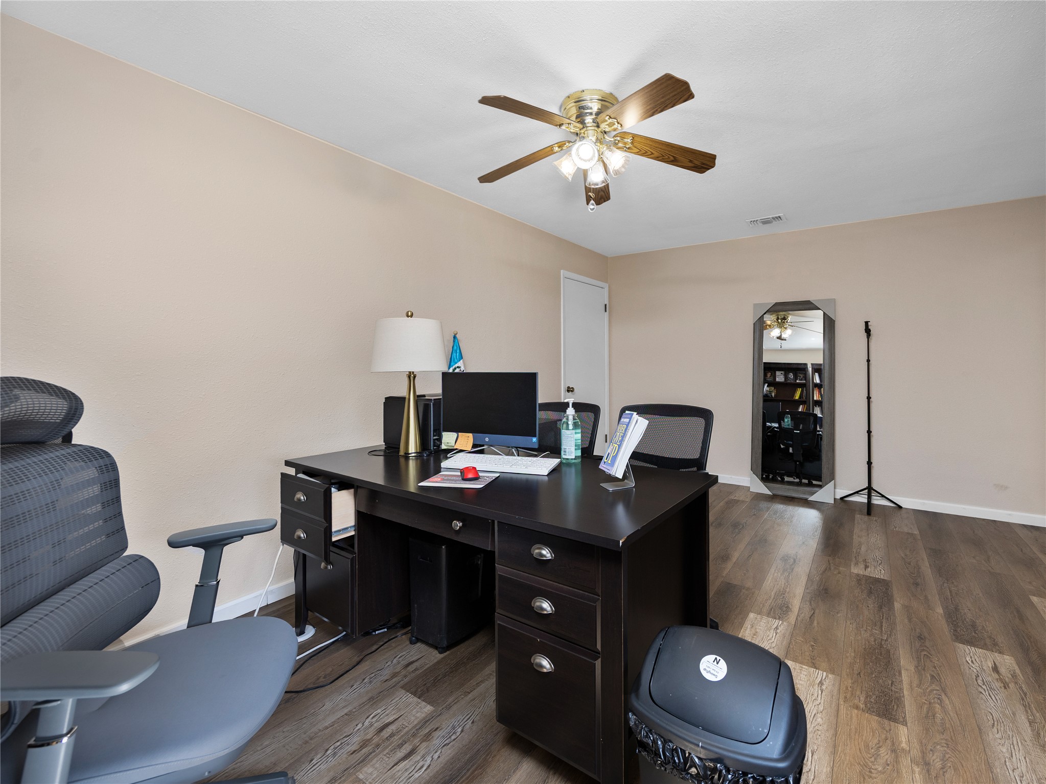 2412 Williamson Road Lockhart, TX 78644 - Photo 11 of 36 Dedicated room featuring wood-finish flooring, a ceiling fan with light fixture, and neutral-toned walls