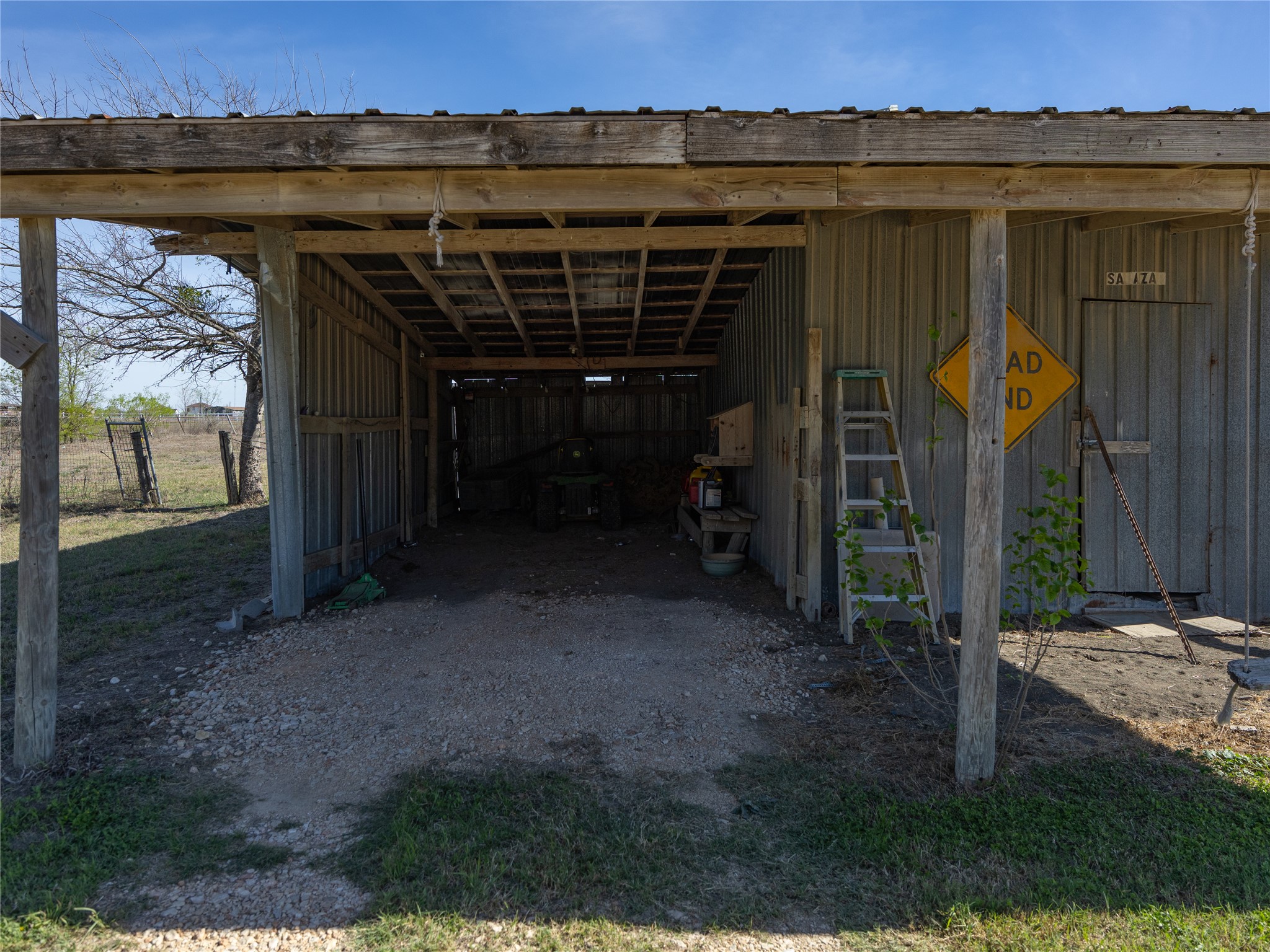 2412 Williamson Road Lockhart, TX 78644 - Photo 13 of 36 Covered outdoor structure featuring wood support beams and a metal roof