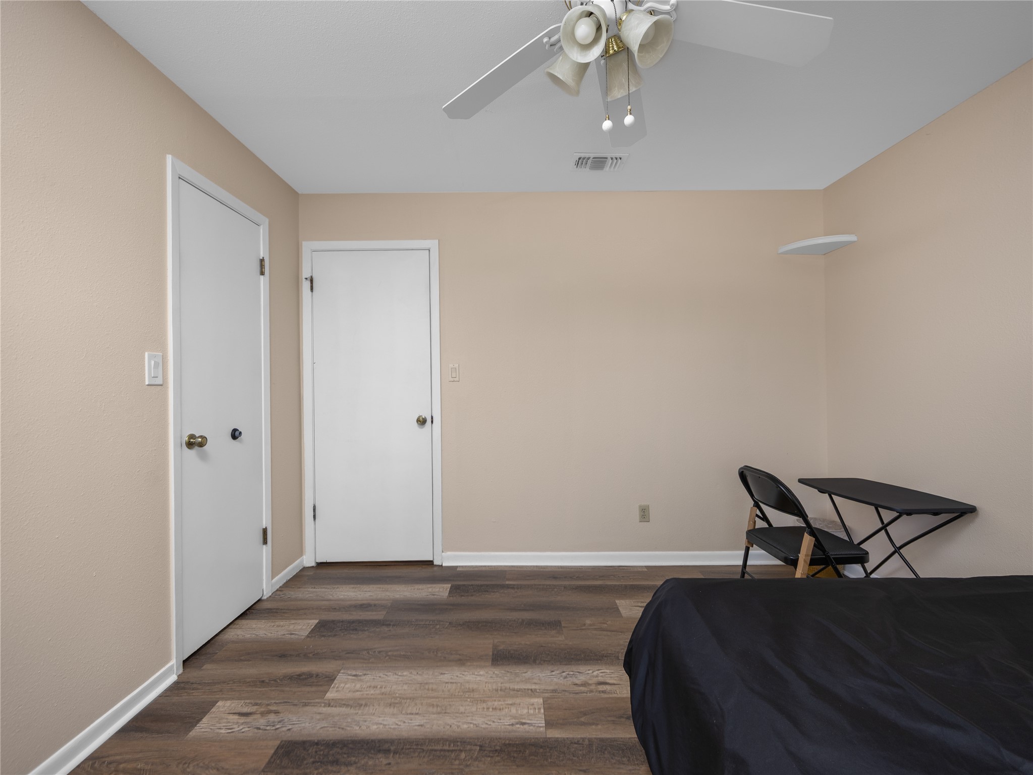 2412 Williamson Road Lockhart, TX 78644 - Photo 15 of 36 Neutral-toned walls complement wood-finish flooring throughout this room