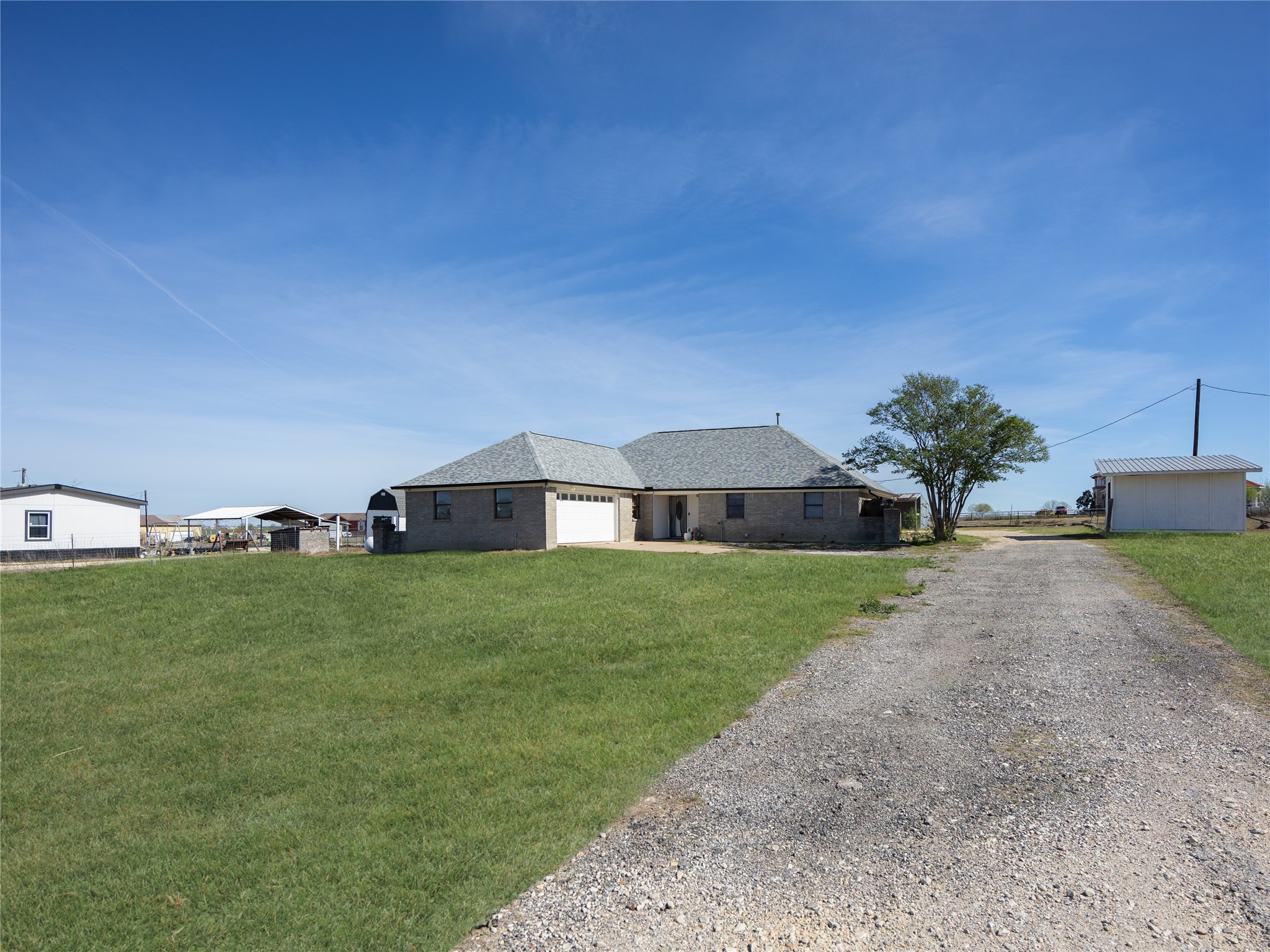 2412 Williamson Road Lockhart, TX 78644 - Photo 20 of 36 Ranch-style residence featuring a brick exterior and an attached two-car garage