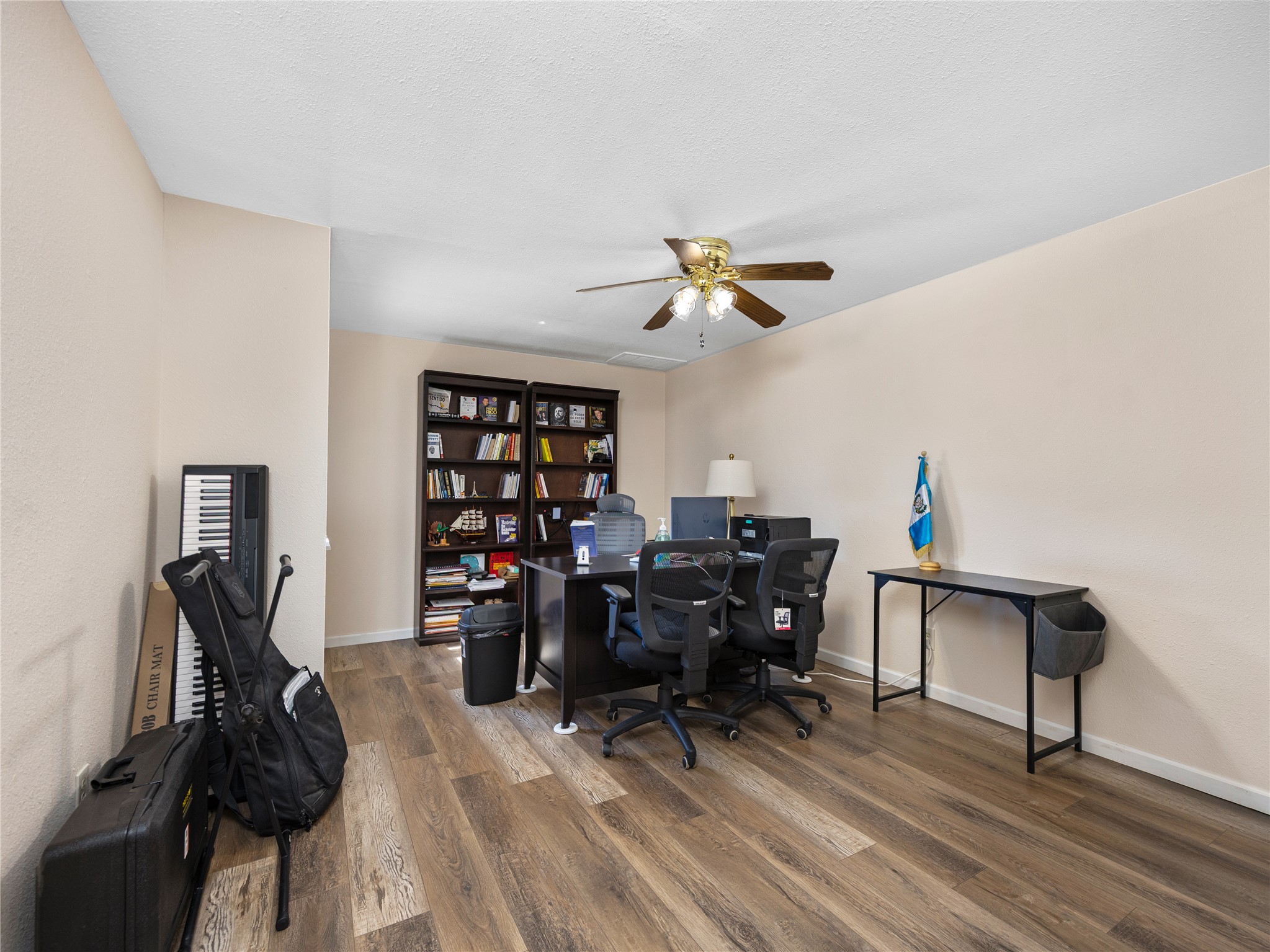 2412 Williamson Road Lockhart, TX 78644 - Photo 30 of 36 Room featuring wood-finish flooring, neutral wall tones, and a ceiling fan with integrated lighting
