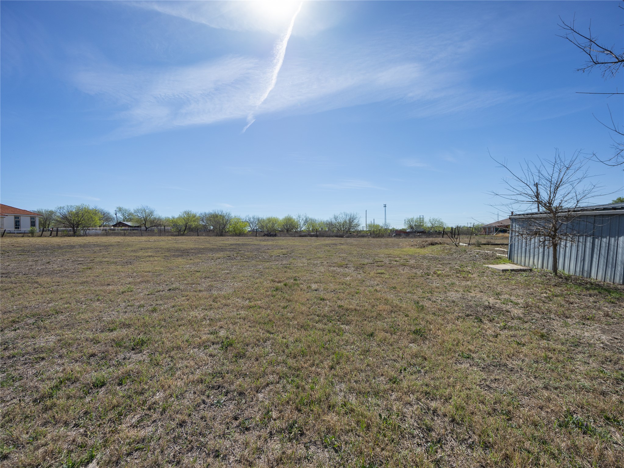 2412 Williamson Road Lockhart, TX 78644 - Photo 33 of 36 Expansive cleared land parcel with a clear, open sky