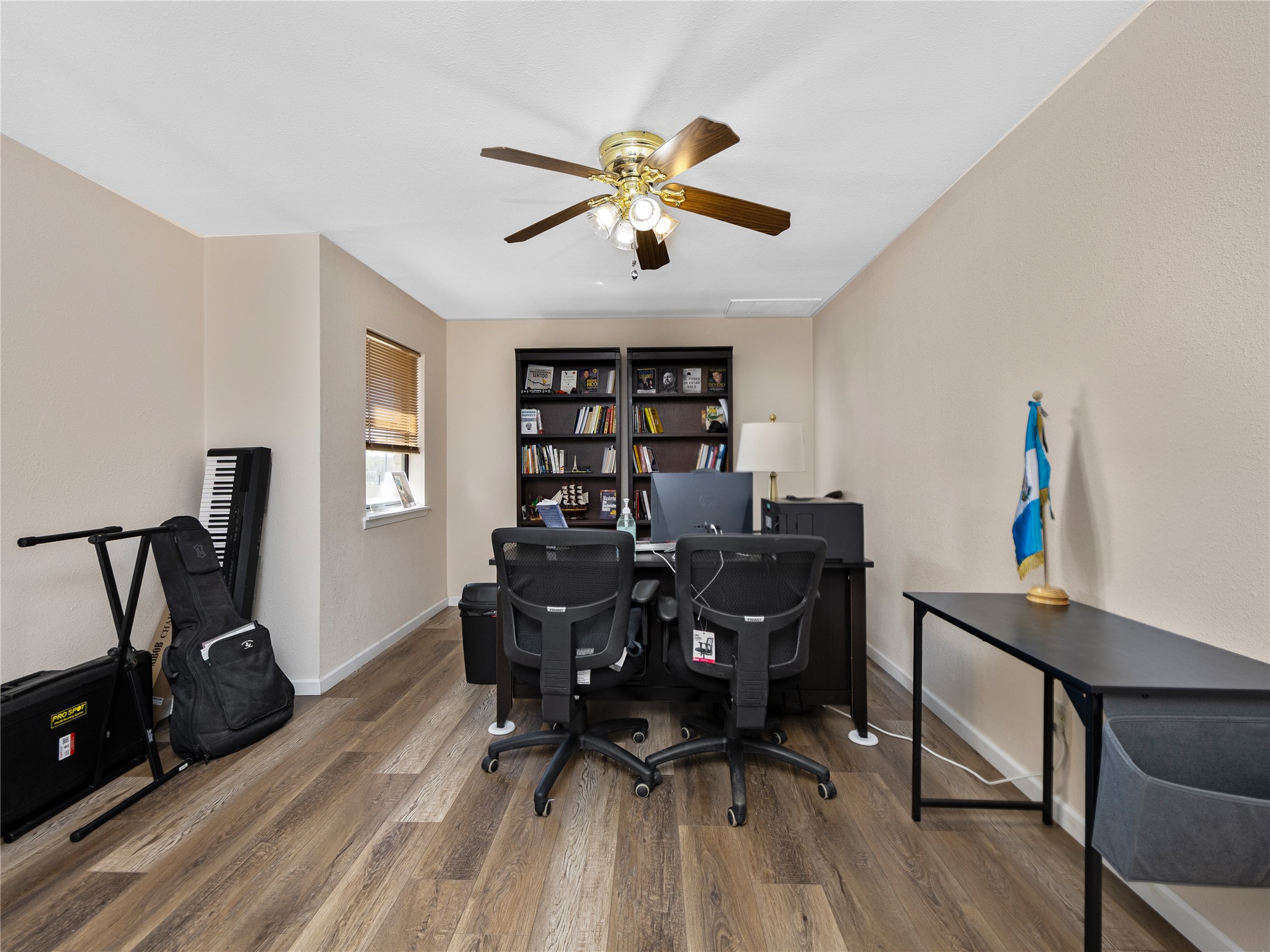 2412 Williamson Road Lockhart, TX 78644 - Photo 10 of 36 Versatile room featuring wood-finish flooring and a ceiling fan with integrated lighting
