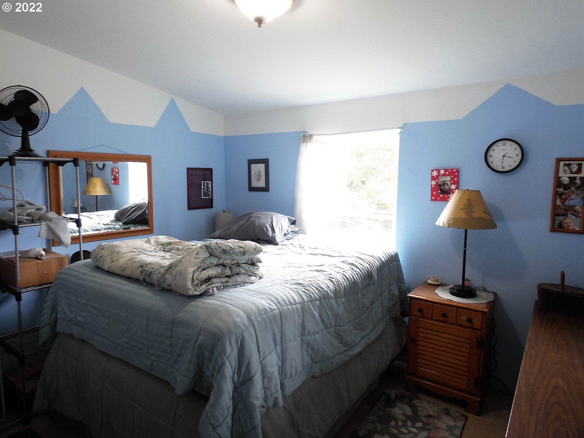 198 Council Creek Road Riddle, OR 97469 - Photo 15 of 24 a bedroom with a bed and a chandelier