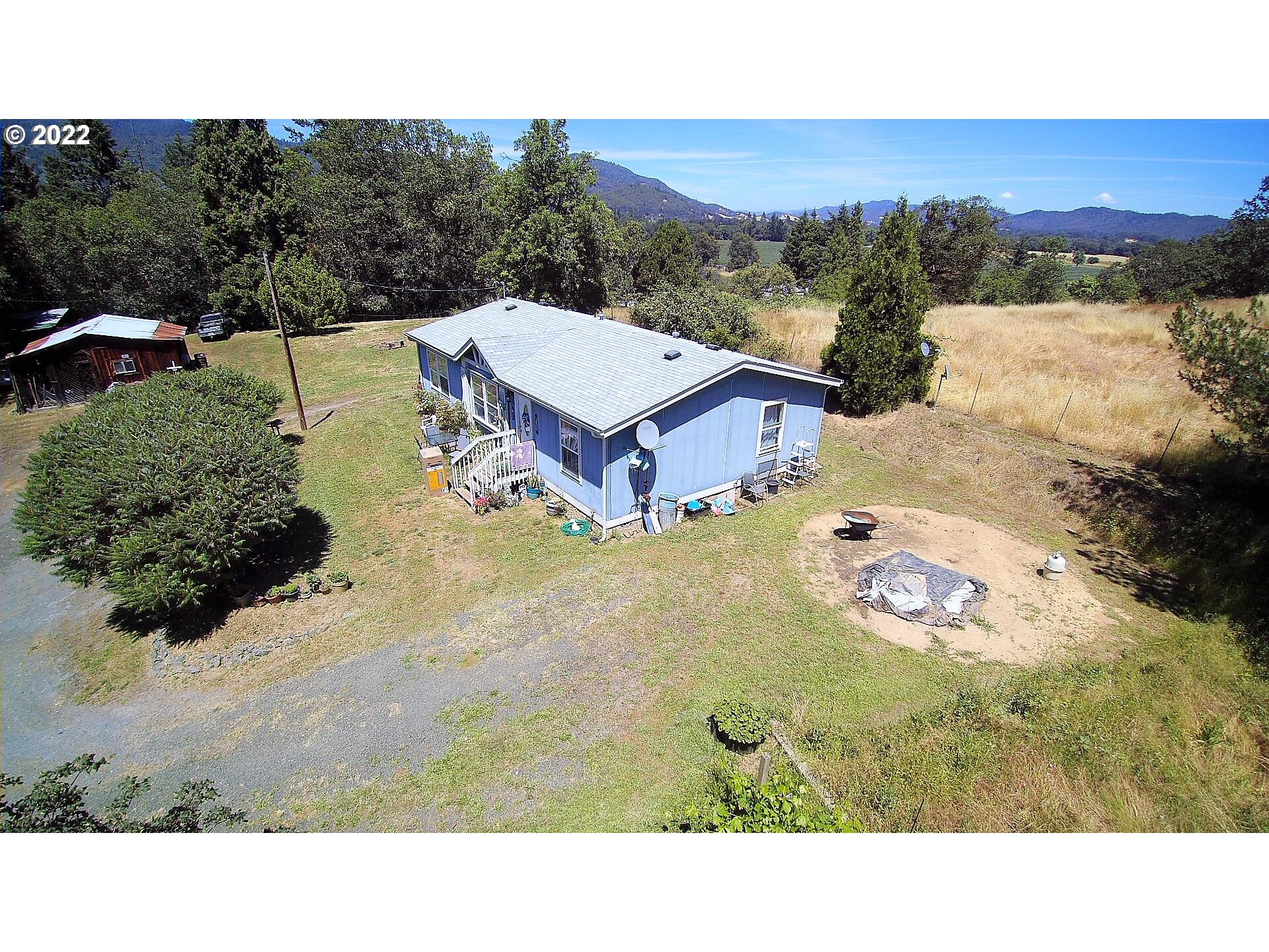 198 Council Creek Road Riddle, OR 97469 - Photo 3 of 24 a aerial view of a house with a yard