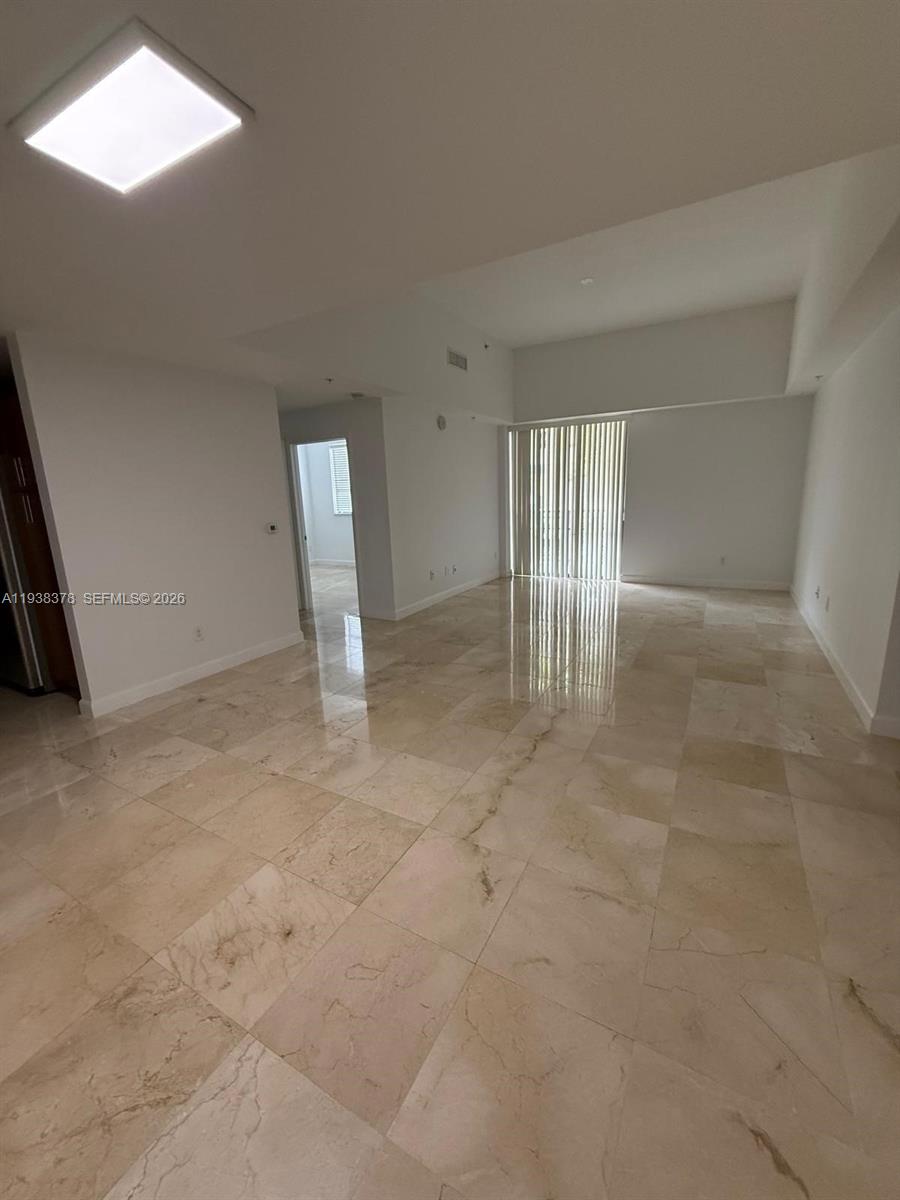 8390 Southwest 72nd Avenue, Unit 520 Miami, FL 33143 - Photo 23 of 61 an empty room with a fireplace and windows