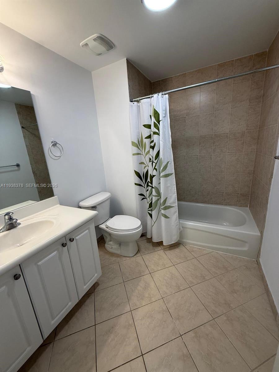 8390 Southwest 72nd Avenue, Unit 520 Miami, FL 33143 - Photo 33 of 61 a bathroom with a granite countertop sink a toilet and shower