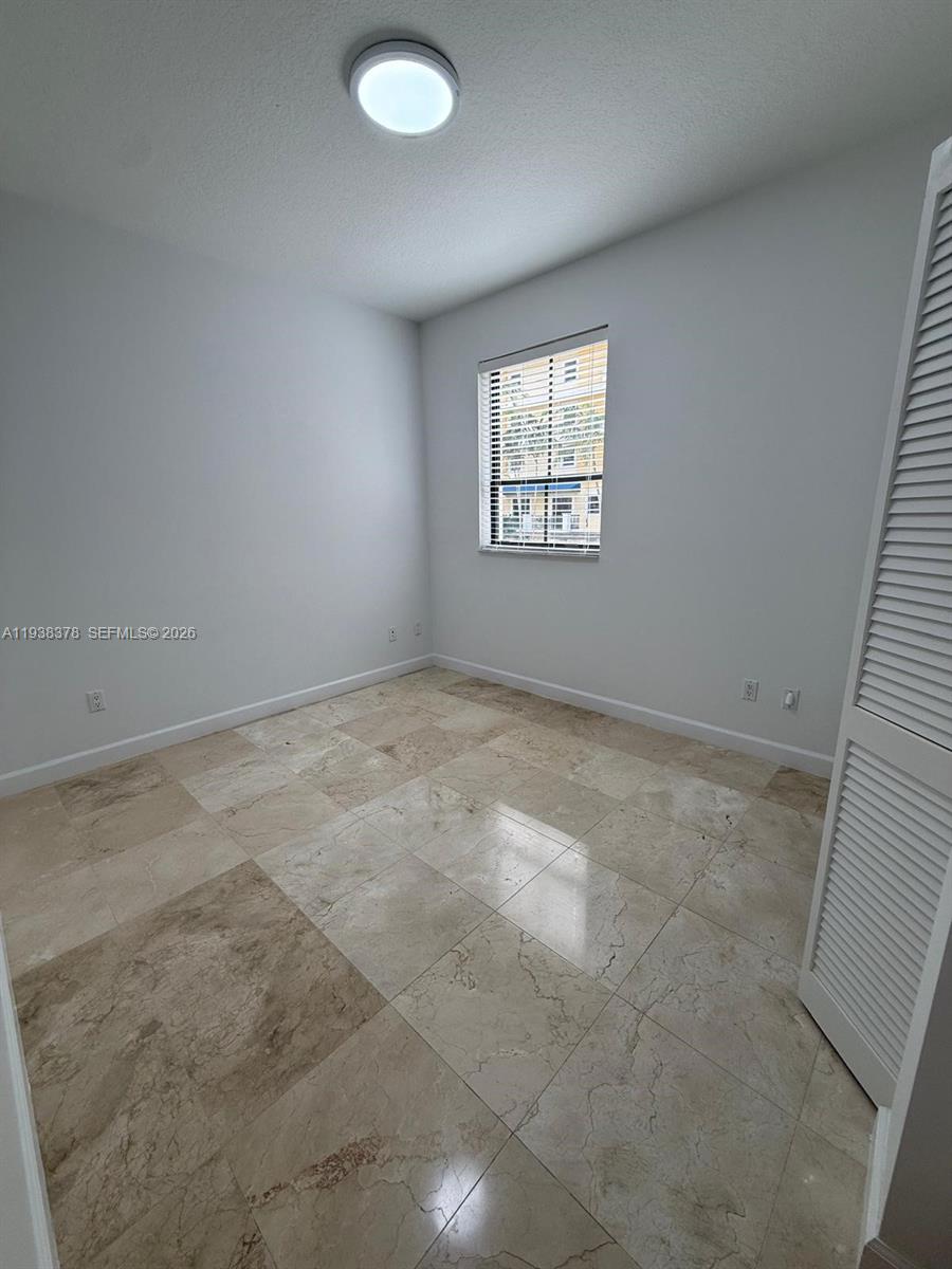 8390 Southwest 72nd Avenue, Unit 520 Miami, FL 33143 - Photo 36 of 61 an empty room with windows
