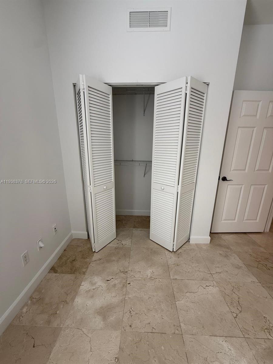 8390 Southwest 72nd Avenue, Unit 520 Miami, FL 33143 - Photo 40 of 61 an empty room with a fireplace