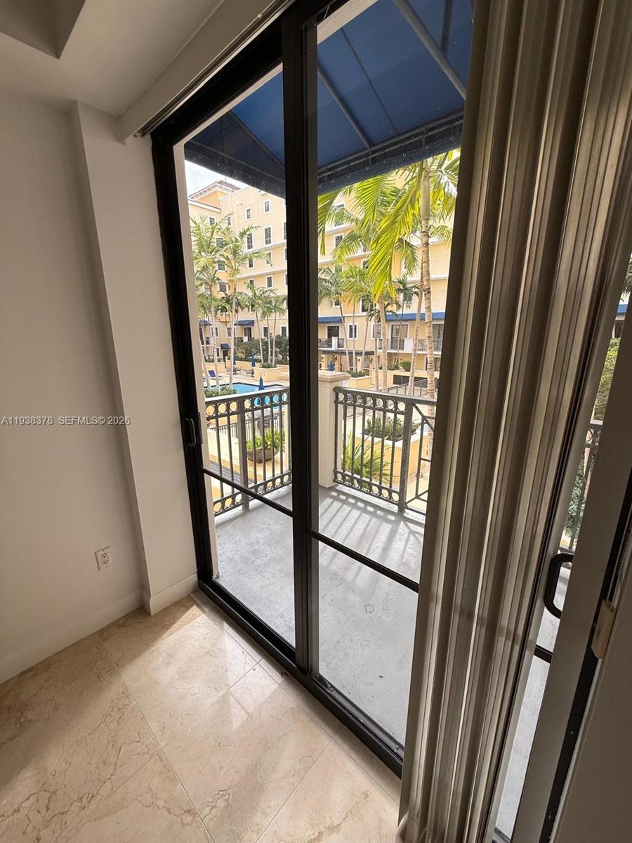 8390 Southwest 72nd Avenue, Unit 520 Miami, FL 33143 - Photo 41 of 61 a view of a glass door and the balcony