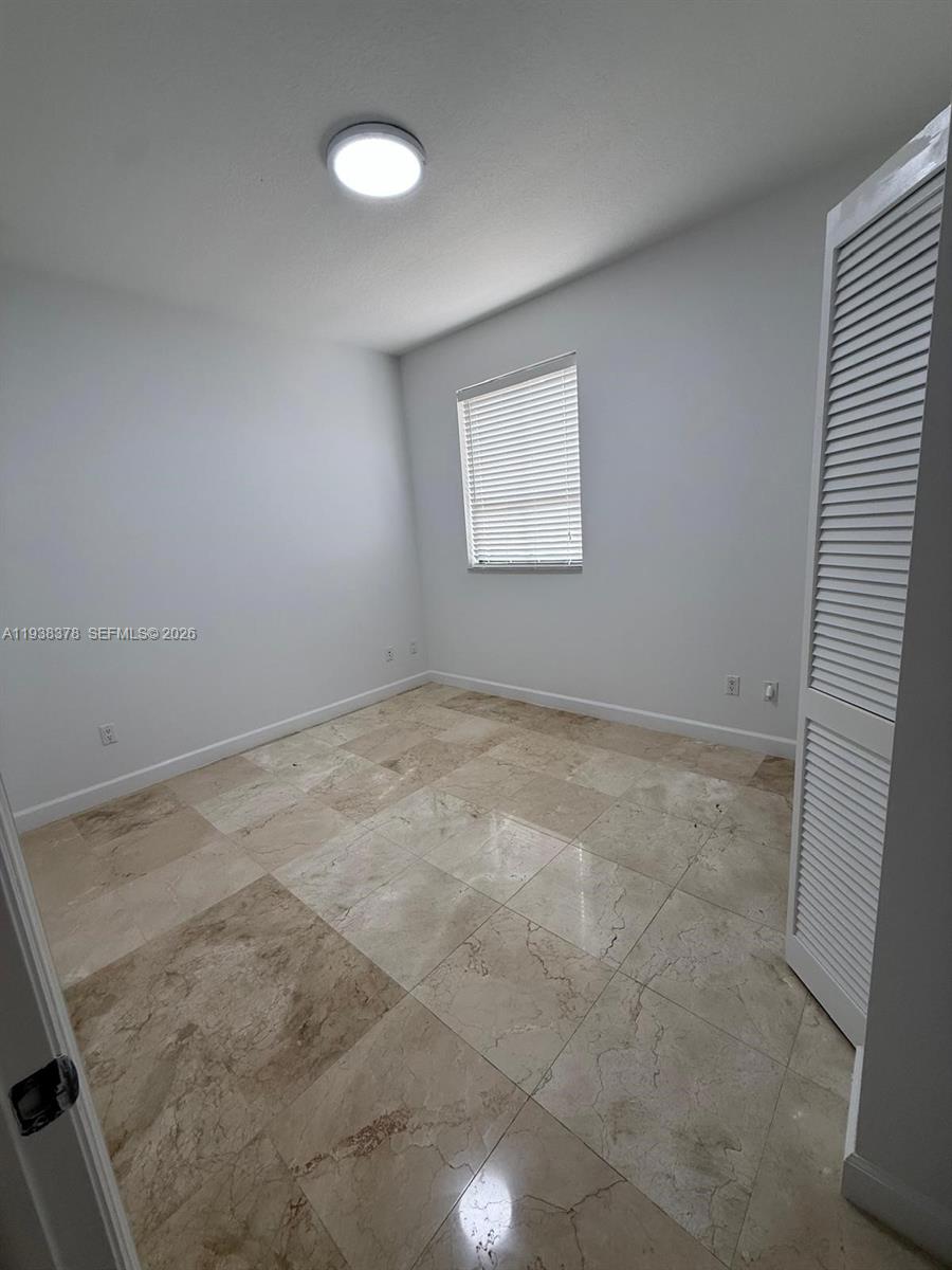 8390 Southwest 72nd Avenue, Unit 520 Miami, FL 33143 - Photo 54 of 61 an empty room with a workbench