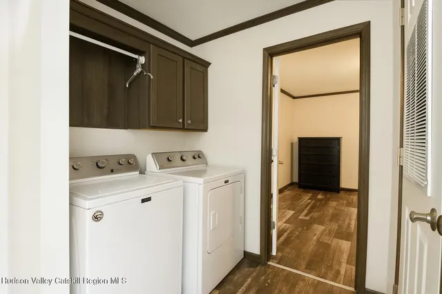 a view of walk in closet with washer and dryer