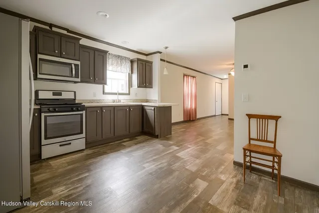 a kitchen with stainless steel appliances granite countertop a stove top oven a sink and dishwasher