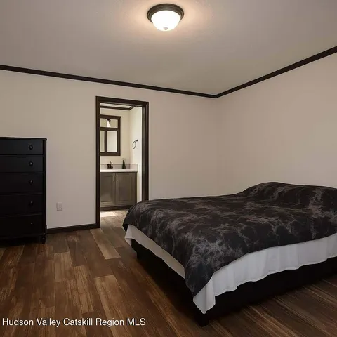 a bedroom with a bed and dresser