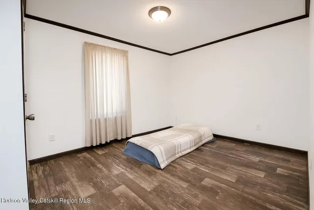 a view of a room with wooden floor and a window